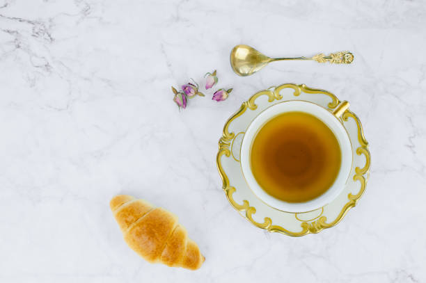 istock Breakfast table with cup of tea and Croissants. 1195422184
