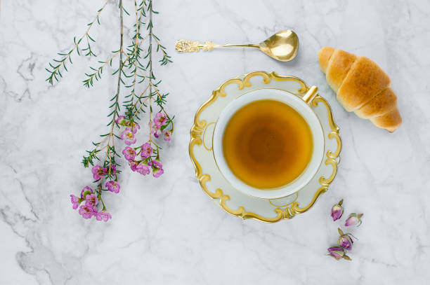 istock Breakfast table with cup of tea and Croissants. 1195422231