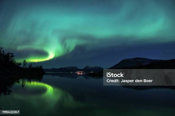 Northern Lights Reflecting In The Water In Abisko Sweden Stock Photo - Download Image Now