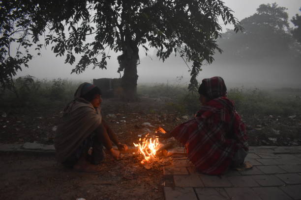 Cold wave in India Peoples are warm himself by fire on the winter cold morning in Kolkata, India. kolkata night stock pictures, royalty-free photos & images