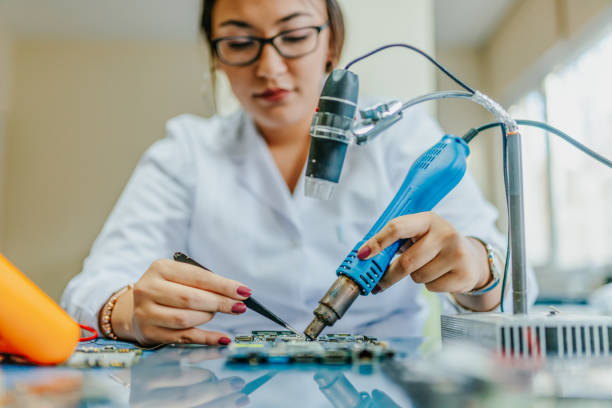 istock Female electronic engineer repairing computer motherboard in laboratory 1195425406