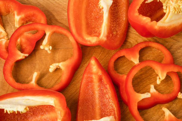 istock red bell pepper cut into pieces on a wooden board 1195426866