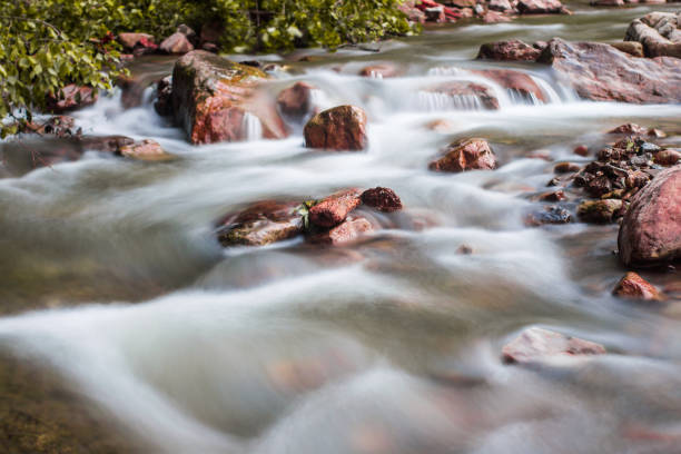 istock Little cascade falls of water over mountain river rocks. 1195427728