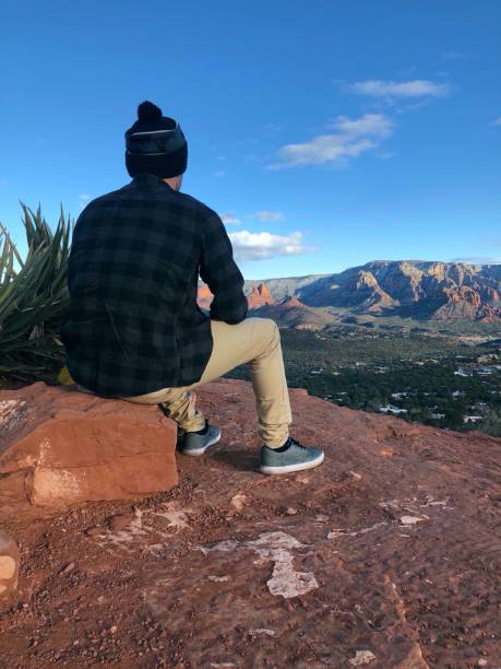 istock Solo Traveller Millenial sitting on rock 1195429580