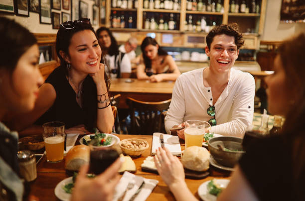 istock Group of friends sitting in a pub 1195433342