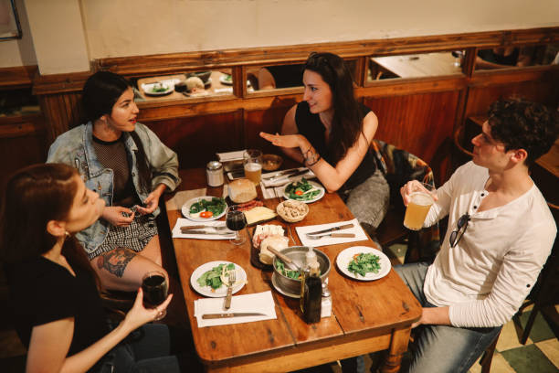 istock Group of friends sitting in a pub 1195433835