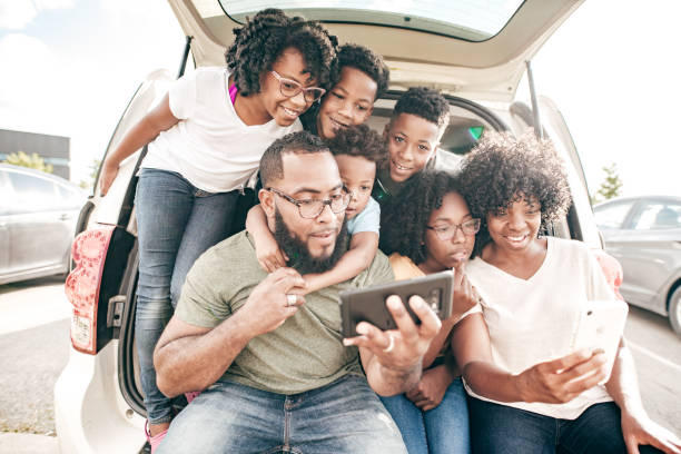 istock Family before the road trip taking selfies 1195434178