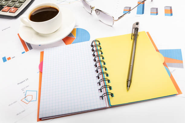 istock Notepad with a pen, coffee and papers business concept 1195435422