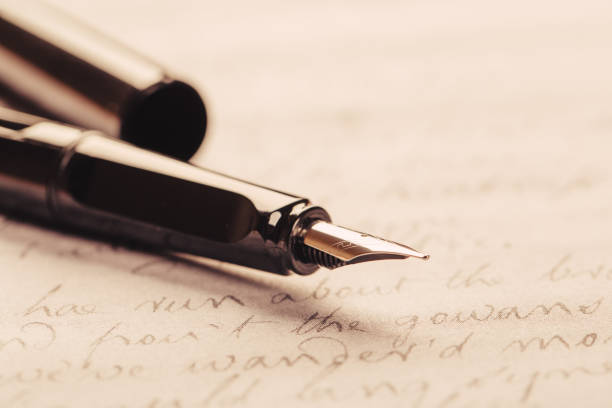 istock fountain pen on paper with ink text closeup 1195436572