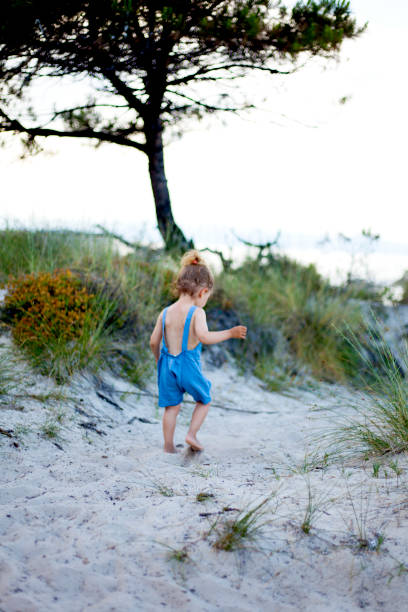 istock cute girl at the beach 1195442422
