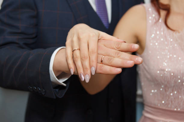 istock Just Married Hands with wedding rings 1195444336
