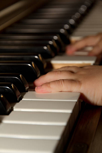 Child playing piano stock photo