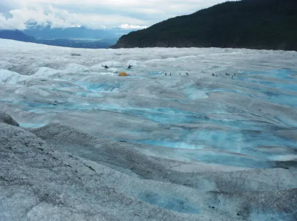 Photo of Two Helicopters, Tent And A Dozen Of Hikers On Mendenhall Glacier, Alaska