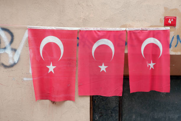 istock Three Turkish flags of different sizes hung on the wall. 1195447454