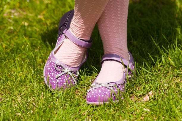 istock New shoes on children's legs 1195447476