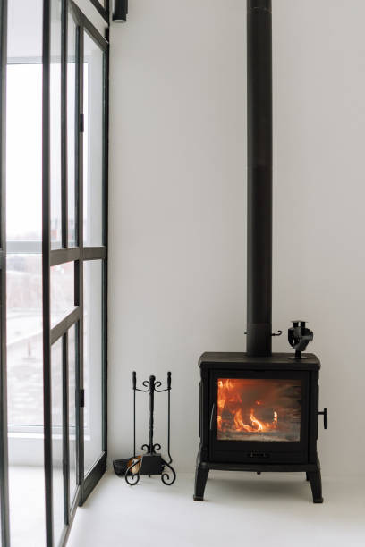 istock Modern Black Metal Fireplace Burning Wood Fire 1195447639