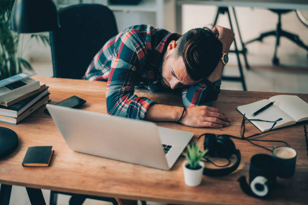 istock Young businessman experiencing stress during a late night at work 1195448665