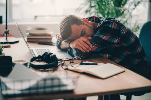 istock Young businessman experiencing stress during a late night at work 1195449722