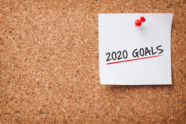 istock White Sticky Note With New Year 2020 Goals And Red Push Pin On Cork Board 1195450966