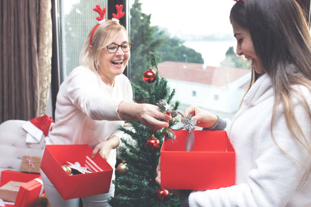 istock Celebrating Christmas, decorating the christmas tree 1195453767