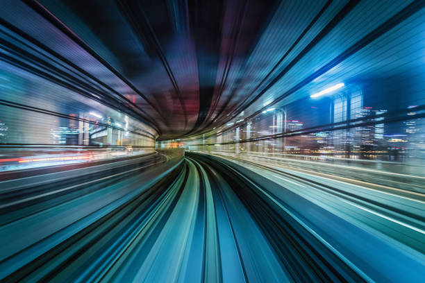 Futuristic High Speed Train Motion Blur Abstract Tokyo Japan High speed train speeding over the rails through a tunnel at night. Illuminated Cityscape Buildings in the background. Motion Blur. Long Exposure. Edited, Composite Night Skyline. Odaiba, Tokyo, Japan, Asia tokyo bullet train stock pictures, royalty-free photos & images