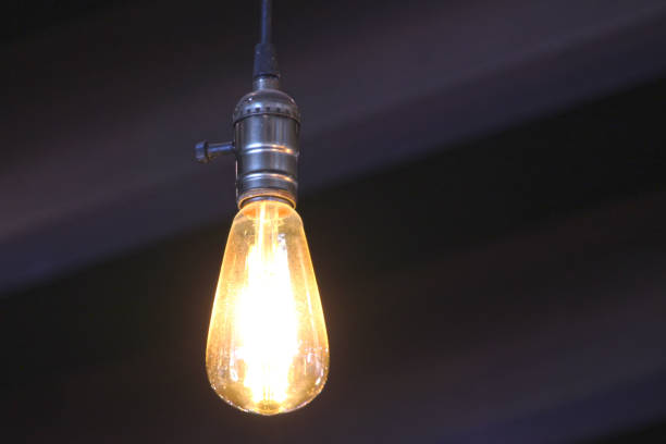 istock Yellow light bulb isolated on black background 1 left 1195457715