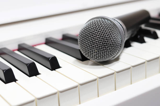 istock One microphone on the piano keyboard 1195459758