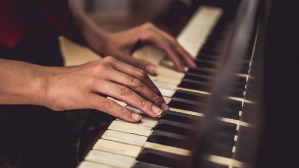 istock Woman plays piano 1195460063