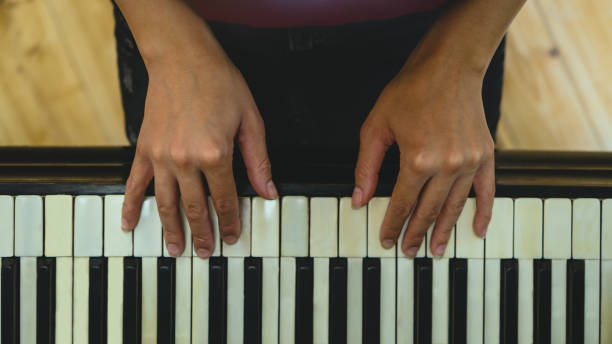 istock Woman plays piano 1195460081