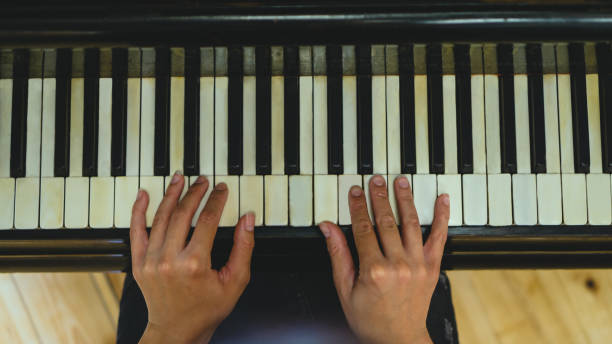 istock Woman plays piano 1195460831