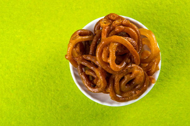 istock Jalebi Indian sweet dish on green background 1195461720