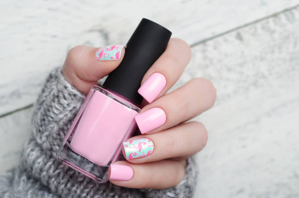 istock Pink manicure with pink flamingo pattern with gray sweater 1195461914