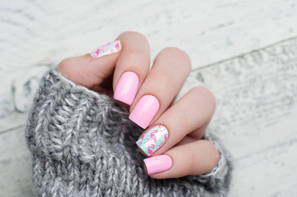 Pink manicure with pink flamingo pattern with gray sweater
