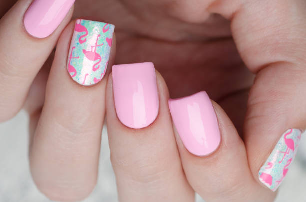 istock Pink manicure with pink flamingo pattern with gray sweater 1195461955