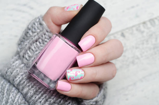 istock Pink manicure with pink flamingo pattern with gray sweater 1195461962