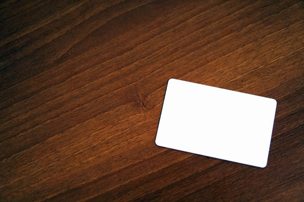 Blank white card over the wood desk stock photo