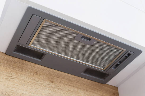 istock gray range hood integrated in a white modern kitchen. 1195463023