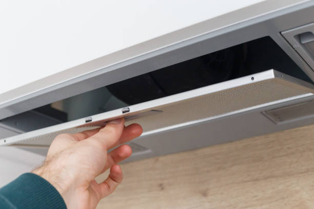 istock Man removing a filter from cooker hood for cleaning or service 1195463045