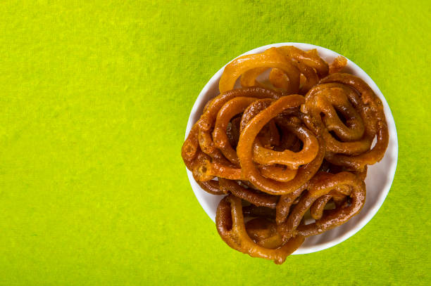 istock Jalebi Indian sweet dish on green background 1195467437