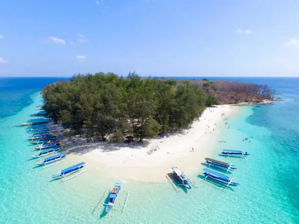 Tropical Island. View of nice tropical empty sandy beach with boats, turquoise water in Gili Nanggu Lombok Indonesia