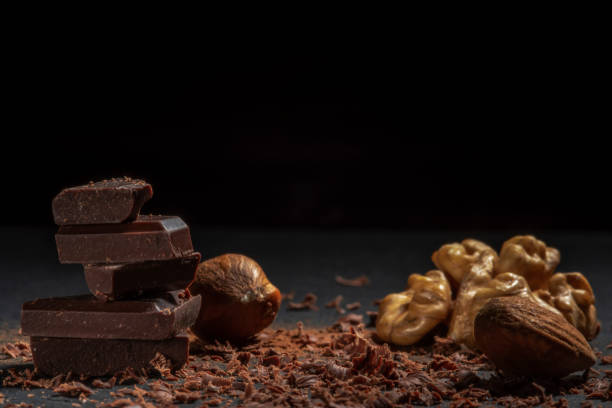 istock Dark chocolate in nuts on a stone. Dark background. 1195468097