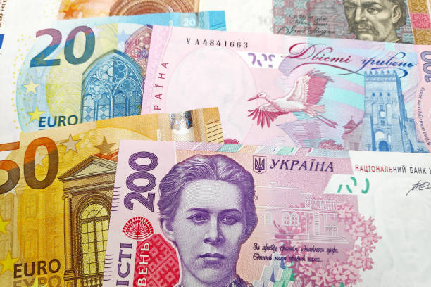 Close-up on a stack of Euros and Ukrainian Hryvnia.