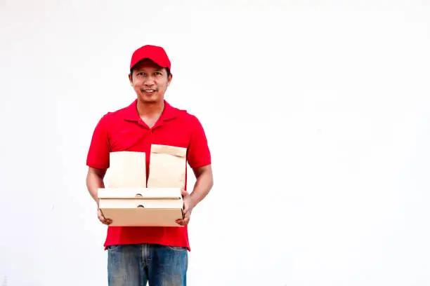 Photo of Men wearing red shirts and hats stand happily with their arms crossed.