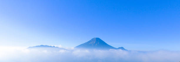 istock Mountain landscape with peaks covered by clouds 1195471252