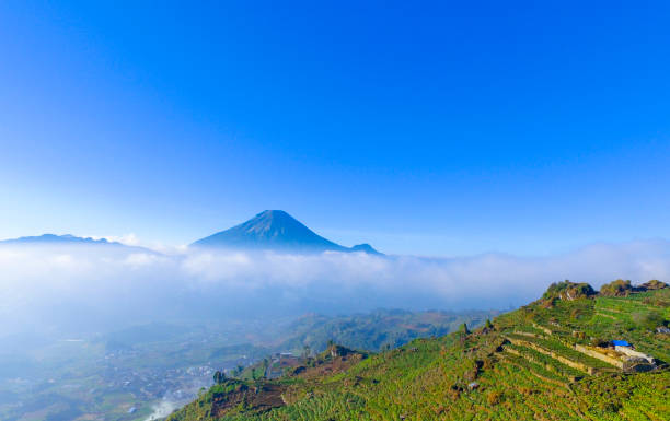 istock Mountain landscape with peaks covered by clouds 1195471379