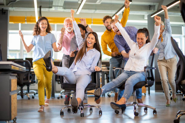 istock Group of joyful colleagues having fun in office. 1195471912