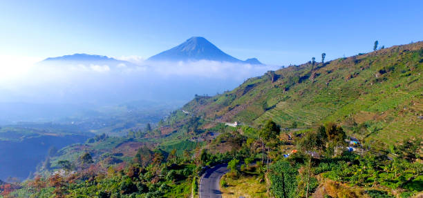 istock Mountain landscape with peaks covered by clouds 1195471921