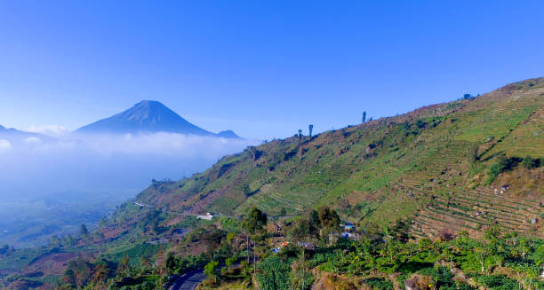 istock Mountain landscape with peaks covered by clouds 1195471925