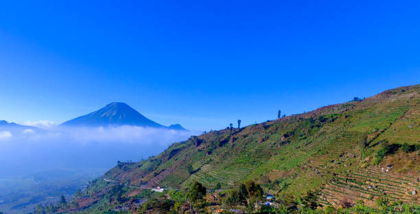 istock Mountain landscape with peaks covered by clouds 1195472439