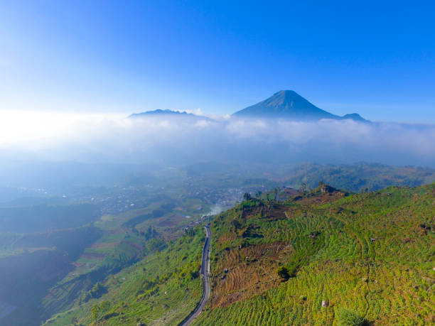 istock Mountain landscape with peaks covered by clouds 1195472489